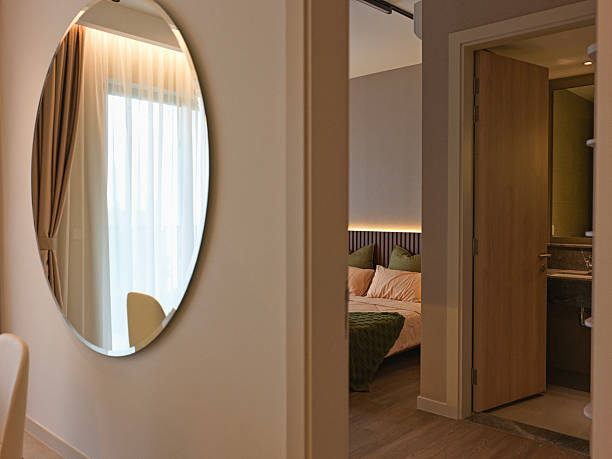 istock Interior View of Bedroom Through Hallway with Wall Mirror 2216511306