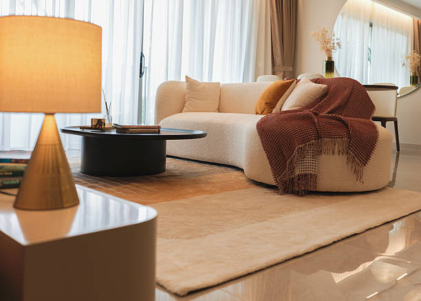 istock Modern Cozy Living Room with Curved Sofa and Warm Natural Light 2216511339