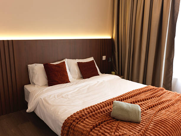 Modern Cozy Bedroom with Warm Lighting and Earth-Tone Bedding