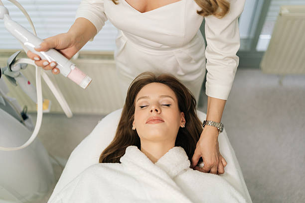 istock Top view of unrecognizable beautician performing mesotherapy treatment with specialized device on woman facial skin, targeting skin rejuvenation 2216513102