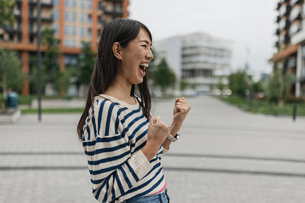 istock Smiling woman expressing victory in urban environment 2216513891