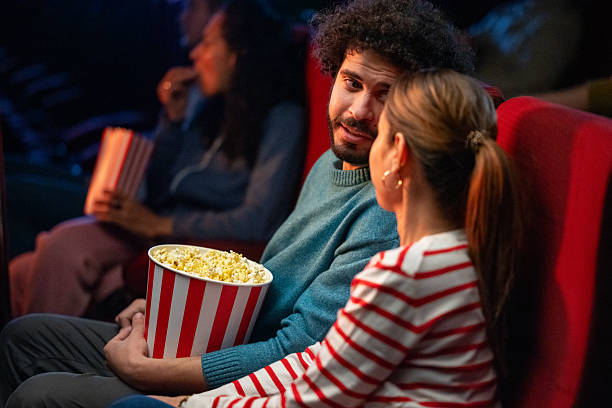 istock Moviegoers enjoy snacks and conversation in a cozy theater setting 2216514018