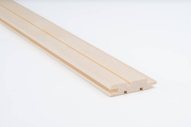 istock Light-colored wood profile with complex grooved design, photographed on white background. Precision-cut component for construction or cabinetry. 2216514038