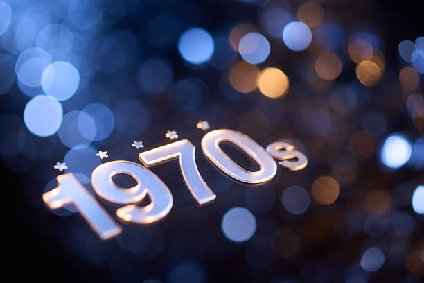 istock Reflective 1970s Silver Text with Stars on Blue and Orange Bokeh Background in Retro Still Life Scene 2216518567