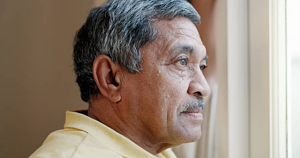 istock Thinking, window and vision with old man in house for retirement, nostalgia and memory. Reflection, perspective and mindfulness with senior person at nursing home for peace, decision and hope 2216519936