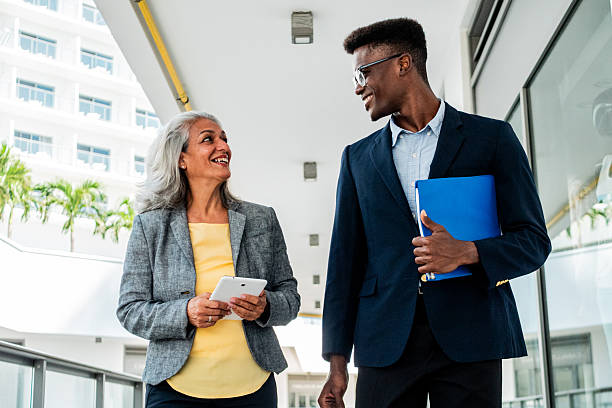 istock Coworkers walking and talking outdoors 2216521081