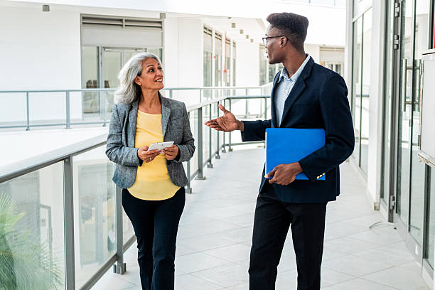 istock Coworkers walking and talking outdoors 2216521084