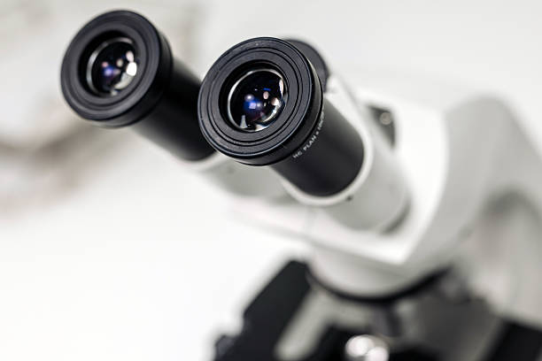 istock A biologist or virologist conducts diagnostic studies by working with a close-up microscope. 2216522046