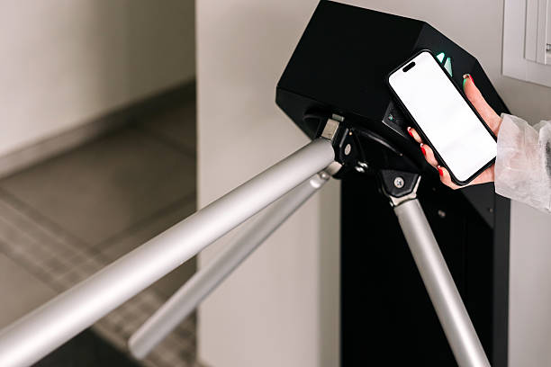 istock Using a smartphone with a white screen to enter the station through the automatic ticket gate. Space for your advertisement. 2216522203