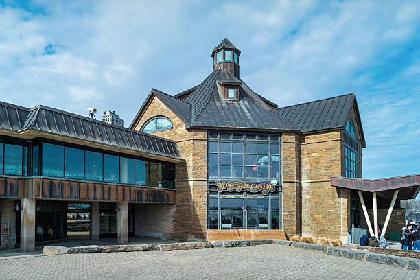The Welcome Centre, gift shop, restaurant and attraction ticket center next to the waterfall in Niagara Falls, Ontario, Canada on a sunny day.