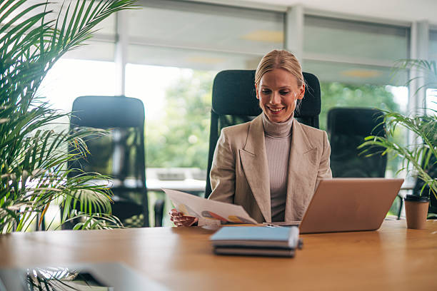 istock Professional woman reviewing documents in office 2216524022