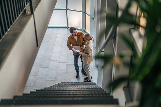 istock Business people discussing a project on office staircase 2216524070