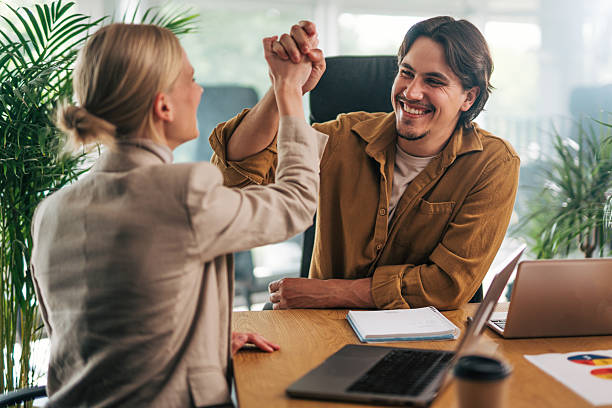 istock Two happy business people giving high five in the office 2216524875