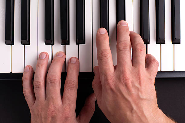 istock A man plays the piano with his hands. Top view. 2216527529