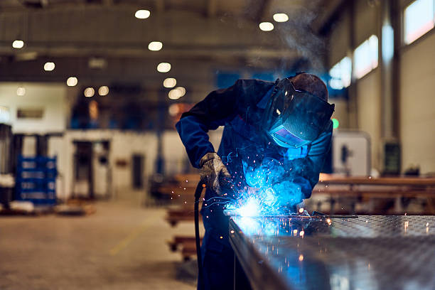 istock Skilled Worker Welding Metal in Industrial Workshop with Protective Gear 2216532790