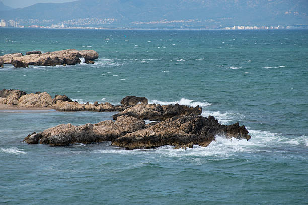 A visit to El Portitxol which has Rock formations, including a unique arch, surround this sandy cove attracting swimmers and sunbathers; on the Gulf of Roses.
