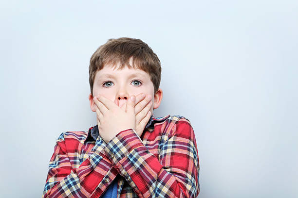 istock Portrait of young boy on grey background 2216535783