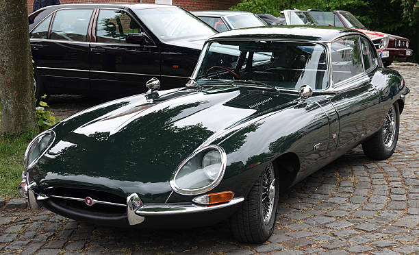 Bad Bentheim, Germany - May 4 2025 The front of a dark green Jaguar E-type from 1969. It's parked between other old-timers