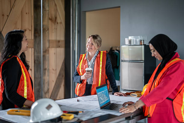 istock Women Collaborating in Construction and Architectural Leadership With Safety Equipment 2216540382