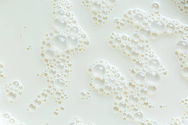 istock Macro milk surface close-up,Macro milk texture,White surface of milk and bubbles and ripples from above birds eye view 2216542107