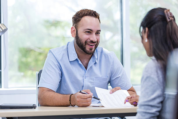 istock Businessman explaining documents to a colleague in office 2216549818