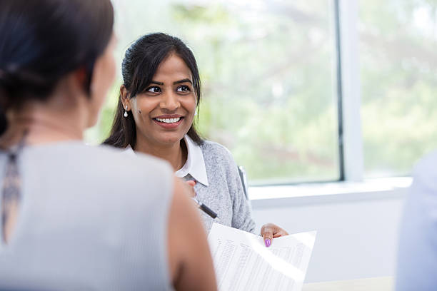 istock Smiling businesswoman explaining business data to colleague 2216549829