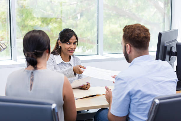 istock Hispanic businesswoman explaining business plan to clients 2216549838