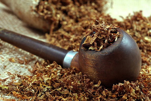 istock Smoking pipe and tobacco on a table. close up 2216550054