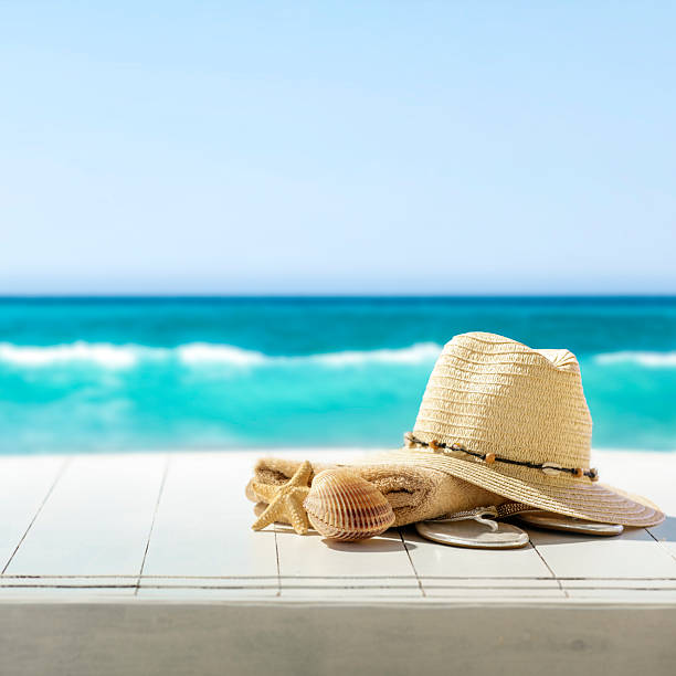 istock Summer composition on wooden pier on sandy beach with blue sea and sky background. Copy space for product or text. 2216550967