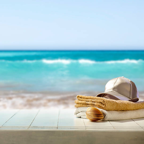 istock Summer composition on wooden pier on sandy beach with blue sea and sky background. Copy space for product or text. 2216552382