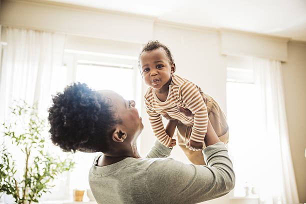 Mother and cute baby boy having fun at home