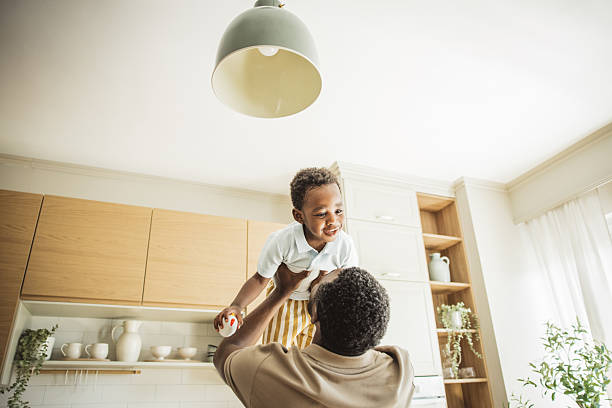 istock Playful father lifting newborn baby 2216552831
