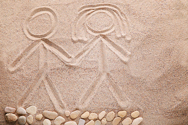 Boy and girl drawn on beach sand