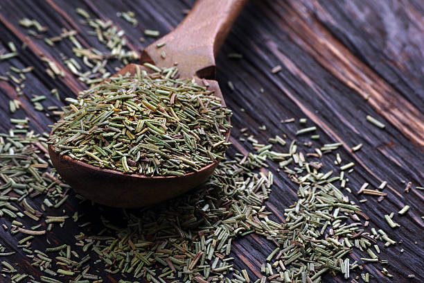 istock dry rosemary in a wooden spoon on the table 2216554564