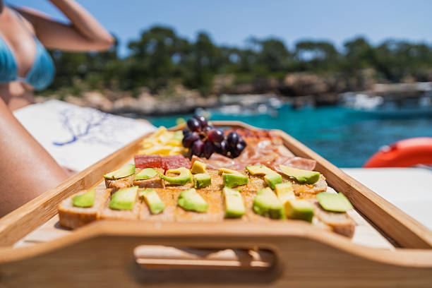 istock Fresh avocado toast and snacks on boat by blue sea 2216556024