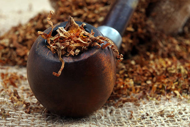 istock Smoking pipe and tobacco on a table. close up 2216557456