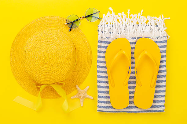 istock Beach towel with summer accessories on color background, top view 2216566081
