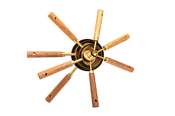 istock Various Copper Measuring Cups with Wooden Handle on a White Background 2216567229