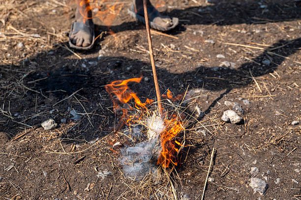 many sticks with stick bread over a campfire