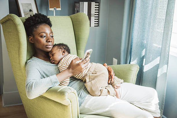 istock Mother holding sleeping baby 2216567394