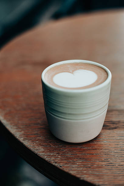istock A warm latte featuring a heart-shaped design rests on a wooden table. Morning hot drink. 2216569705
