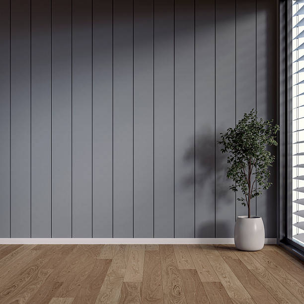 istock A minimalistic, unfurnished interior with a potted plant in front of an empty soft gray paneled accent wall background with copy space, and a window 2216572417