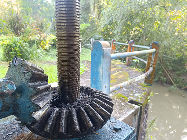An irrigation sluice gate located on a small dam. This sluice gate mechanism is used to control the water level in a river or irrigation channel.