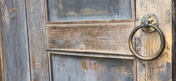 istock Weathered wooden door with a classic iron ring handle, echoing Korean tradition and craftsmanship 2216579707