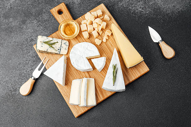 istock Delightful cheese board arrangement featuring various cheeses and accessories 2216581555