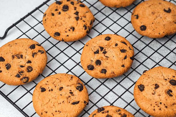 istock Freshly baked chocolate chip cookies cooling on a wire rack 2216581573