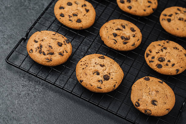 istock Freshly baked cookies cooling on a wire rack in a cozy kitchen setting 2216581583