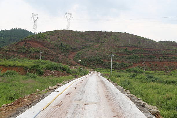 istock The road in front is covered with white fabric, with green grass on both sides and red soil at ground level. 2216583249