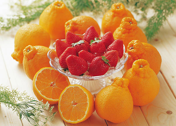 The strawberries are placed in a tall glass container and surrounded by shiranui cherry blossoms to create a cute image.