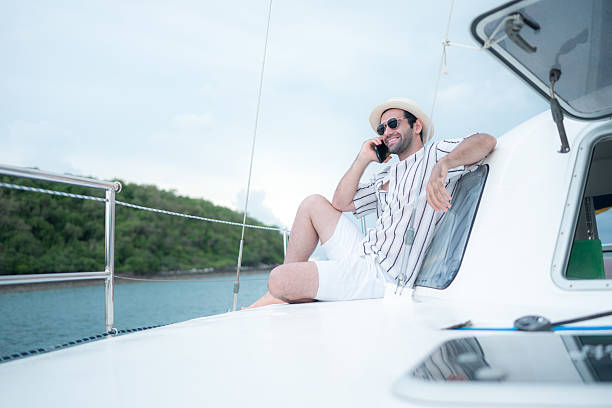 istock A young man is enjoying his seaside adventure aboard a yacht 2216591244